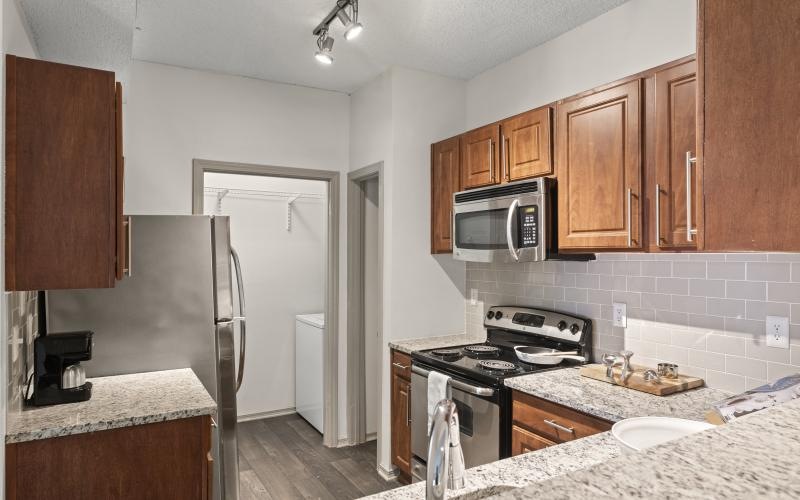 a kitchen with wooden cabinets