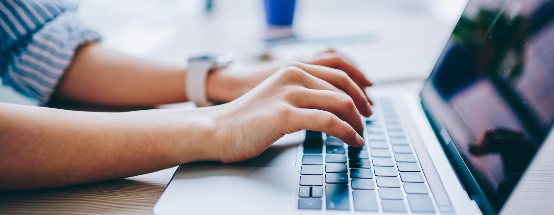 a person typing on a laptop