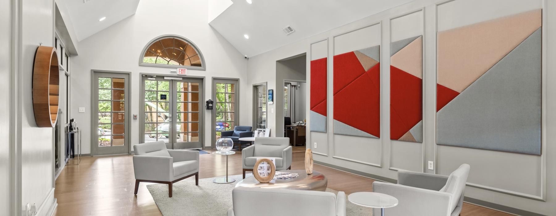 a large living room with white furniture